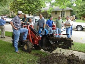 Orinda sprinkler repair team digs a trench